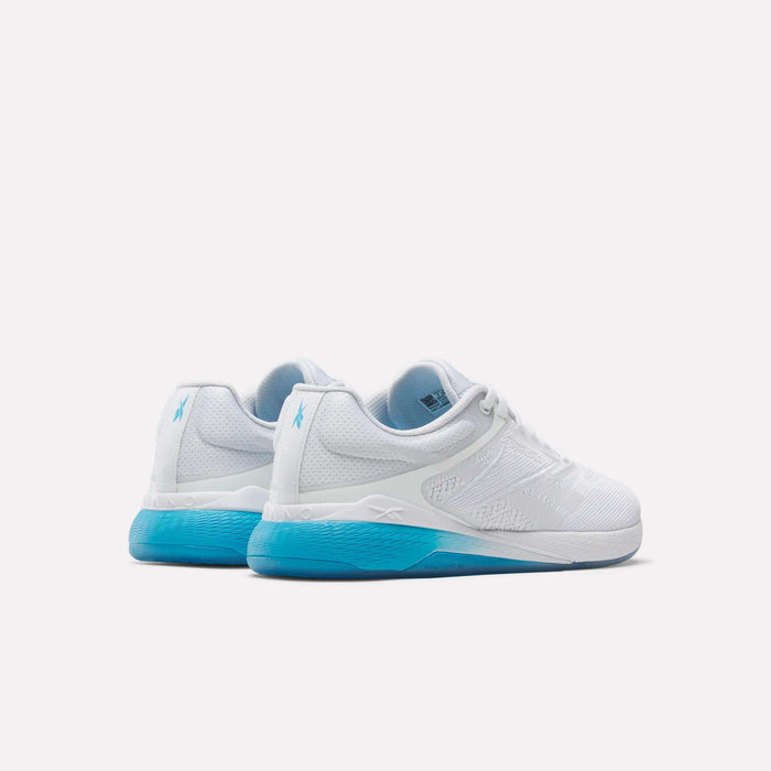 A pair of Reebok Women's Nano X5 Training Shoes in white with light blue accents and soles, displayed on a plain white background to show both the back and side views.
