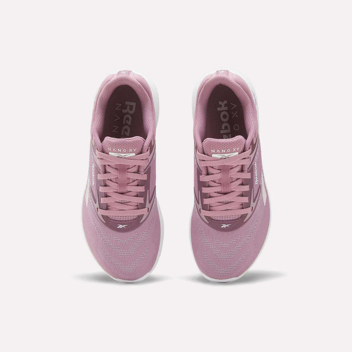 A pair of Reebok Nano X5 Women's Training Shoes in pink, viewed from above with visible laces, mesh upper, dual-density midsole, and white soles on a plain white background—ideal for stylish support during training.
