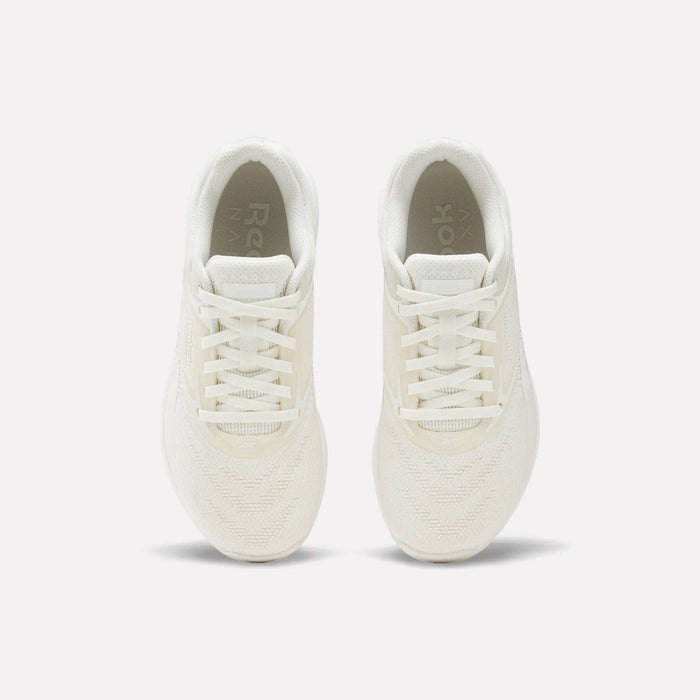 The Reebok Nano X5 Women's Training Shoes, shown from above on a plain white background, highlight their white color, laces, mesh texture, and soles.
