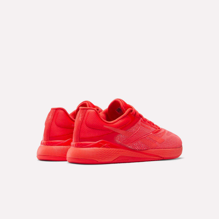 A pair of Women's Nano X5 Training Shoes by Reebok in bright red with textured detailing, displayed from the back and side against a plain white background.