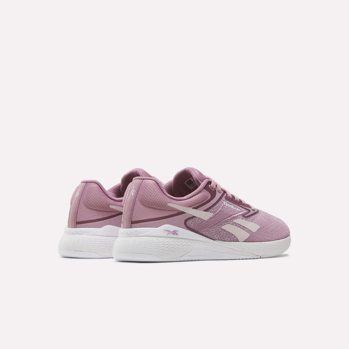 The Reebok Nano X5 Women's Training Shoes feature pink mesh uppers, bold white side logos, dual-density midsoles, and white soles. Displayed against a plain white background.