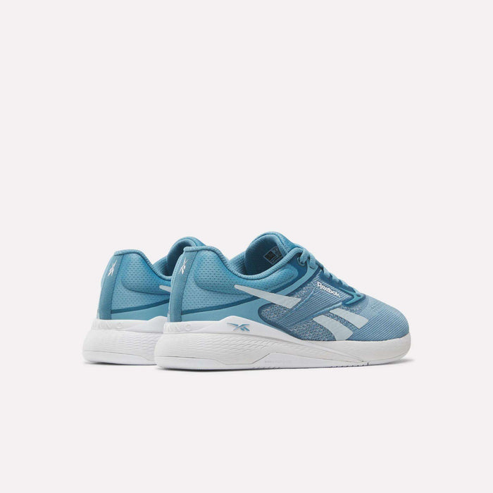 A pair of Reebok Nano X5 Women's Training Shoes in light blue with white soles and accents, designed for optimal comfort, displayed on a plain white background.