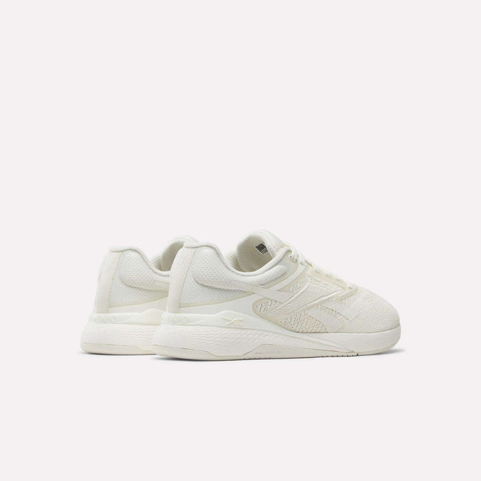 A pair of Reebok Nano X5 Women's Training Shoes in off-white, featuring textured uppers and thick soles, displayed at an angle against a plain white background.