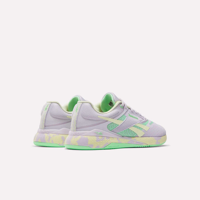The Reebok Women's Nano X5 Training Shoes feature pastel light purple uppers, mint green accents, and yellow-green patterned soles, showcased against a plain white background.