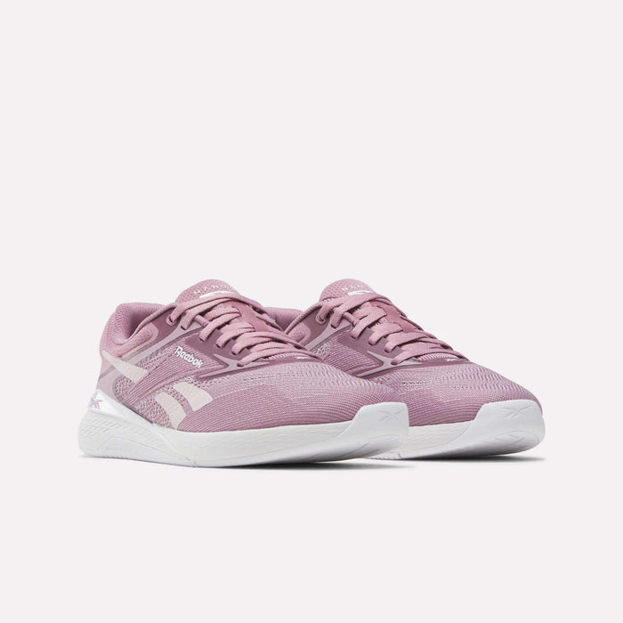 Reebok Nano X5 Women's Training Shoes in pink with white soles, dual-density midsole, and white Reebok logo, shown on a plain white background—perfect for any workout.