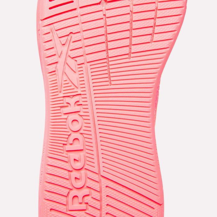 Close-up of the pink sole of Reebok Women's Nano X5 Training Shoes, showcasing the Reebok logo and textured grip lines—ideal for high-performance women’s footwear.