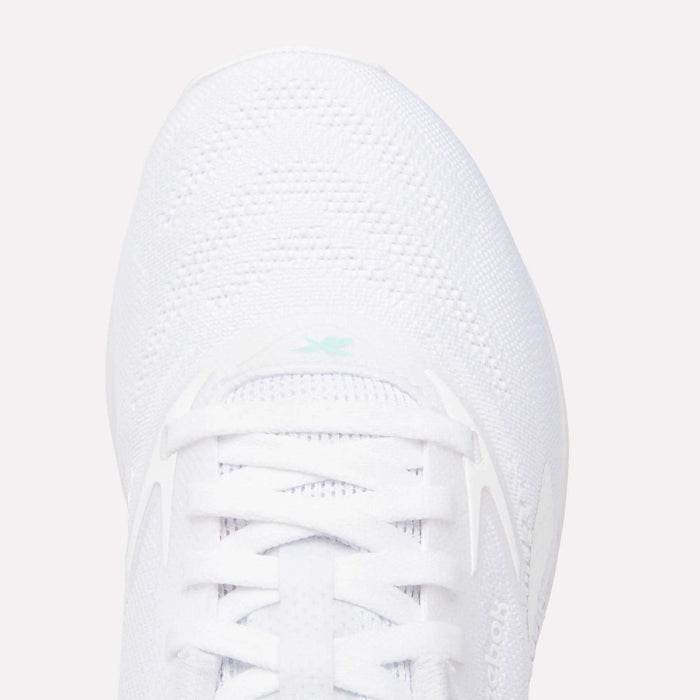 Top view of the Women's Nano X5 Training Shoes by Reebok, featuring comfortable white laces, breathable mesh texture, and a small light blue Reebok logo near the tongue.