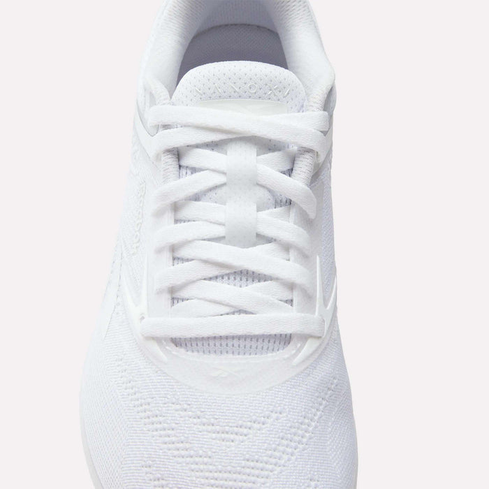 A close-up, top-down view of the Reebok Women's Nano X5 Training Shoes in white, featuring white laces, breathable mesh fabric, and subtle stitched patterns—an essential for any iconic training shoe collection.