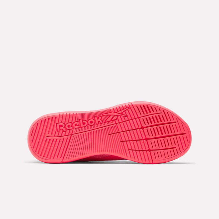 The image displays the bright pink sole of the Reebok Women's Nano X5 Training Shoes, viewed from below. The center features an embossed Reebok logo, and the textured pattern on the sole provides grip.