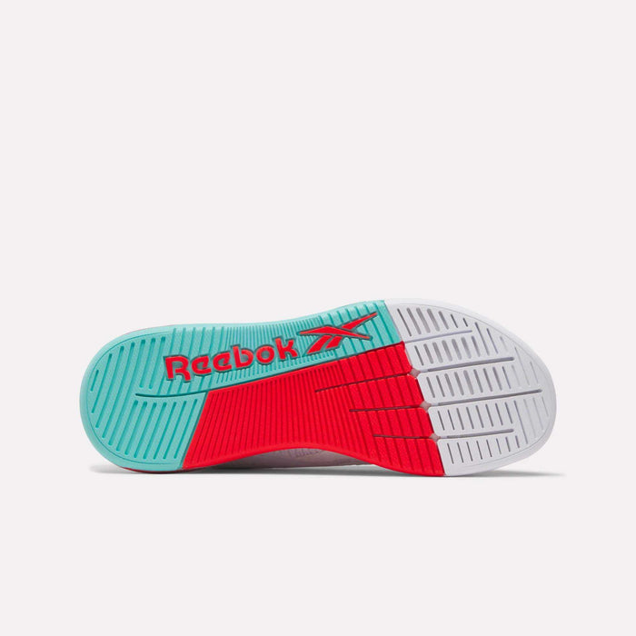 The image shows the sole of Reebok Women's Nano X5 Training Shoes, featuring teal, red, and white colors with a red Reebok logo on teal. The comfortable sole has textured grooves for grip—ideal for active women’s training.