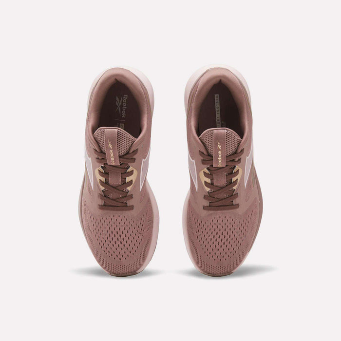 A pair of Reebok Women's Nanoflex 2.0 Training Shoes in pink, shown from above with white side stripes, brown laces, and perforated toes for breathability on a plain white background.