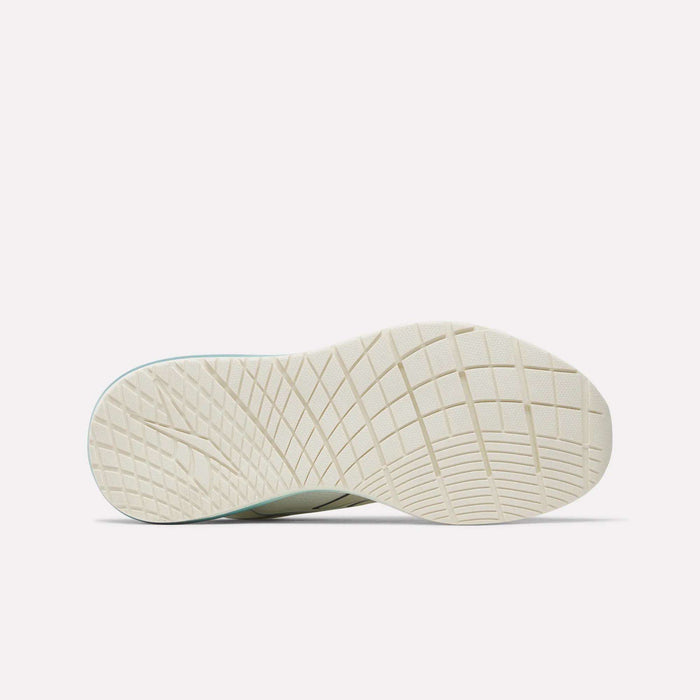 The image displays the textured, light-colored sole of the Reebok Women's Nanoflex 2.0 Training Shoe, featuring a crisscross pattern and shown from the bottom against a plain white background.
