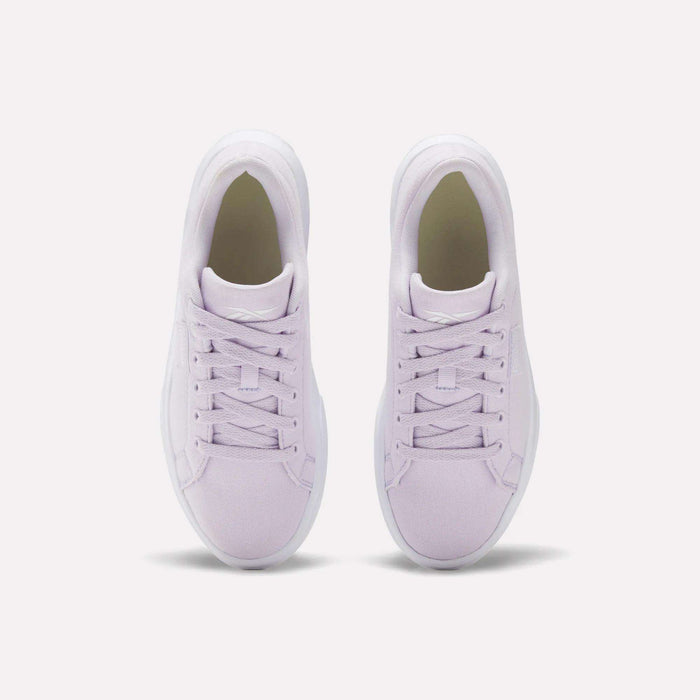 A pair of Reebok Women's OnLux Court Lite Walking Shoes in light purple, shown from above side by side on a white background, feature matching laces and white soles for lightweight, comfortable walks.