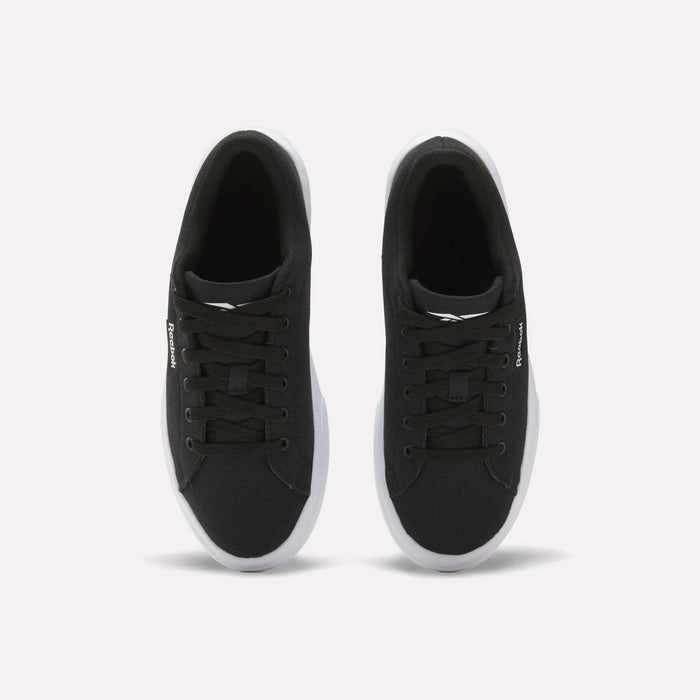 The Reebok Women's OnLux Court Lite Walking Shoes are black sneakers with white soles and black laces, shown from above on a plain white background. Their minimalist design makes them perfect for everyday wear.