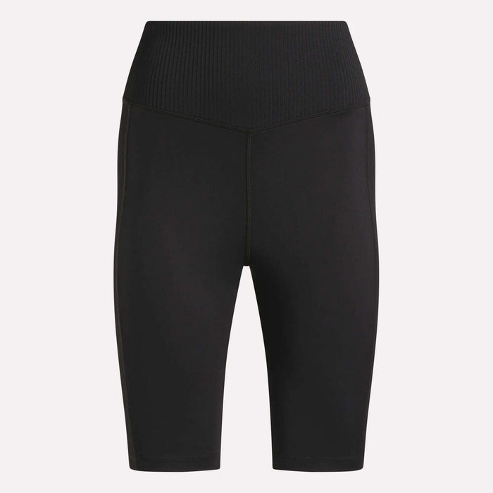 Reebok Women's Peached Biker Shorts 9" in black, featuring a high-rise ribbed waistband, seamless front, mid-thigh length, and soft peached fabric, shown on a plain light background.