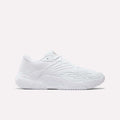 The Women's Phase Evo Tennis Shoes by Reebok are white, low-profile athletic sneakers featuring a textured sole and subtle geometric side patterns, showcased against a plain light background.