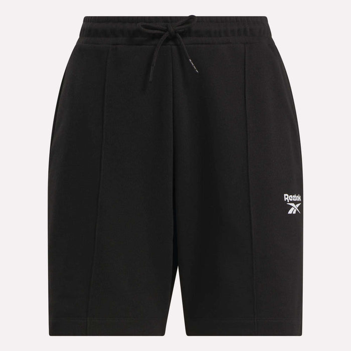 The Reebok Women's Pintuck Long Shorts are black cotton-blend fleece shorts featuring an elastic waistband, drawstring, and a white logo on the left leg. Their simple, casual design is ideal for sports or leisure.