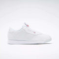 The Reebok Women's Princess Shoes feature a classic white design with a flat sole, cushioned comfort, and subtle branding on the side and tongue—a timeless choice displayed on a plain light background.