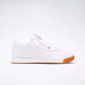 The Reebok Women's Princess Shoes feature a low-cut, classic white design with white laces, subtle logo accents, and a light brown rubber sole, shown against a plain white background.