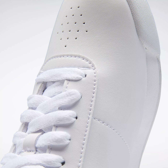 Close-up of Reebok Women's Princess Shoes with white laces, detailed stitching, and small ventilation holes near the toe—an iconic heritage style for a classic women’s sneaker.
