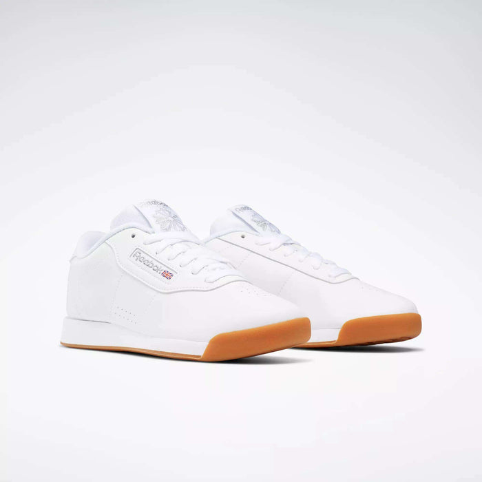 Reebok Women's Princess Shoes in classic white with gum rubber soles, shown on a white background. Featuring subtle Reebok logos, these shoes deliver timeless style and superior cushioning for all-day comfort.