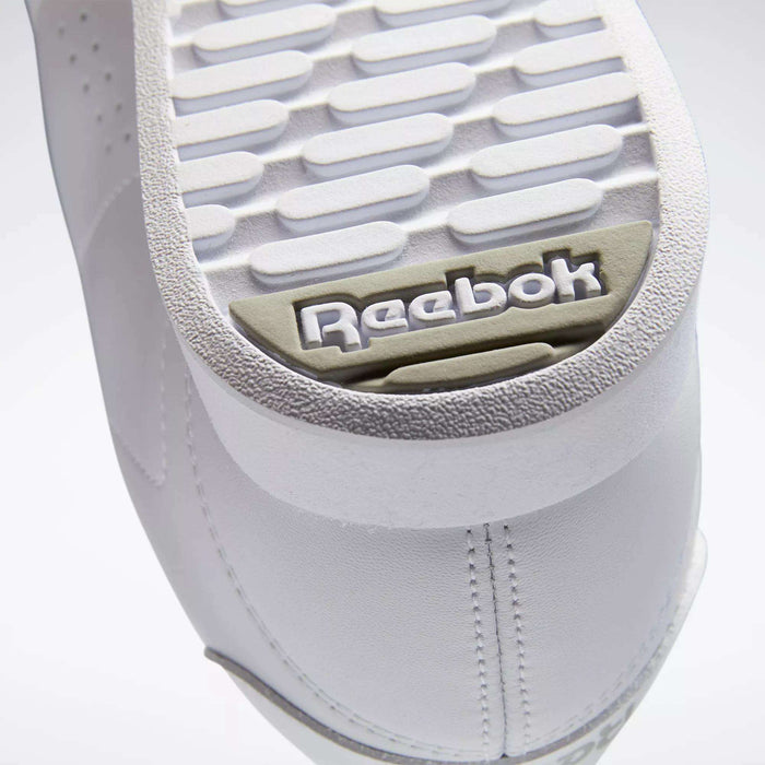 Close-up of the white sole on Reebok Women's Princess Shoes, highlighting the textured tread and gray-beige embossed Reebok logo near the heel—a classic heritage detail from this iconic brand.