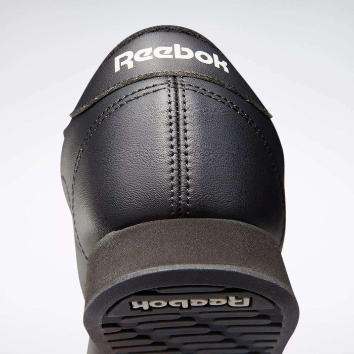 Close-up of the heel and sole of the black Reebok Women's Princess Shoes, featuring cushioned comfort and white Reebok logos on the back and bottom for classic heritage style.