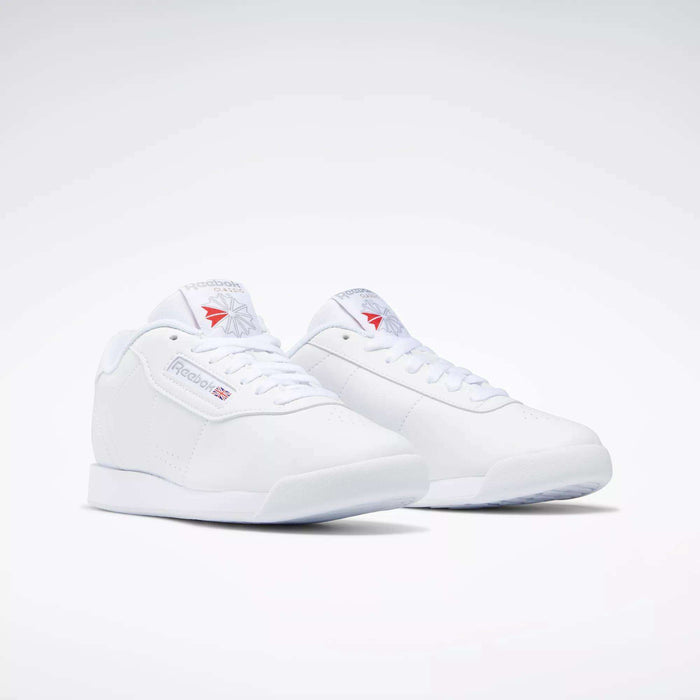 The Reebok Women's Princess Shoes feature a classic low-top design with lace-up fronts and subtle Reebok branding on the sides, tongue, and heel, highlighting heritage style against a plain white background.