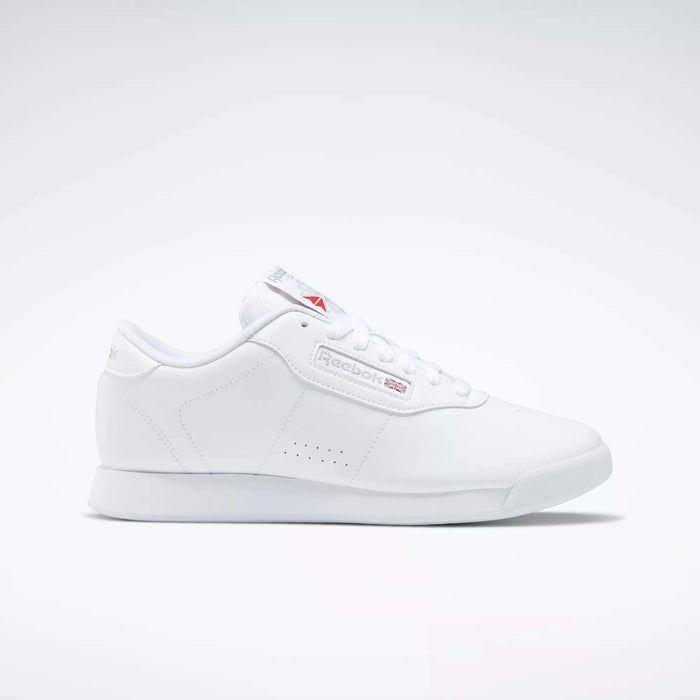 The Reebok Women's Princess Wide Shoes are classic white low-top sneakers for women, featuring subtle Reebok branding and the Union Jack logo on the side and tongue, shown against a plain light background.