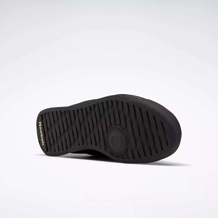 The image shows the black rubber sole of the Reebok Women's Princess Wide Shoes, lying on its side against a white background. The textured sole pattern offers grip, and the Reebok logo appears near the heel.