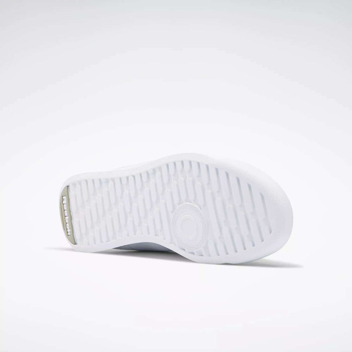 The image displays the white rubber sole of Reebok Women's Princess Wide Shoes, featuring a textured tread and central circular design, set against a plain light gray background.