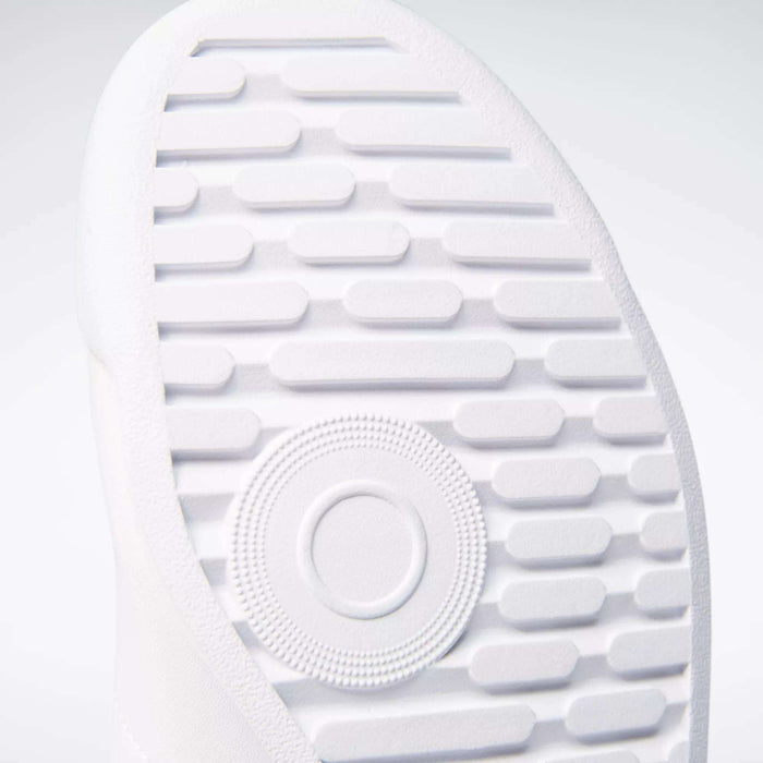 Close-up of the textured white sole on Reebok Women's Princess Wide Shoes, showing horizontal grooves, a central circular pattern, and heritage cushion detailing for comfort.