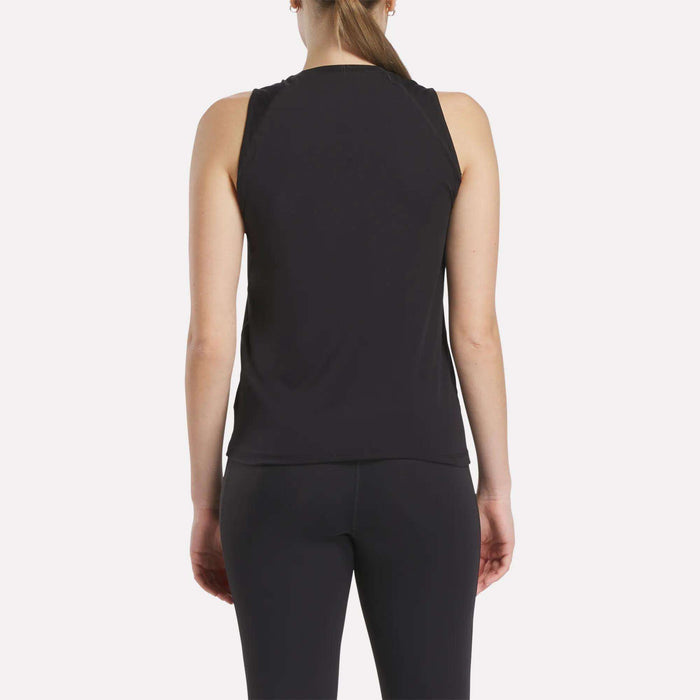 A woman with a ponytail is seen from behind wearing the Women's Reebok x F45 Training Tank Top and black leggings against a plain white background, ideal for F45 Training sessions.