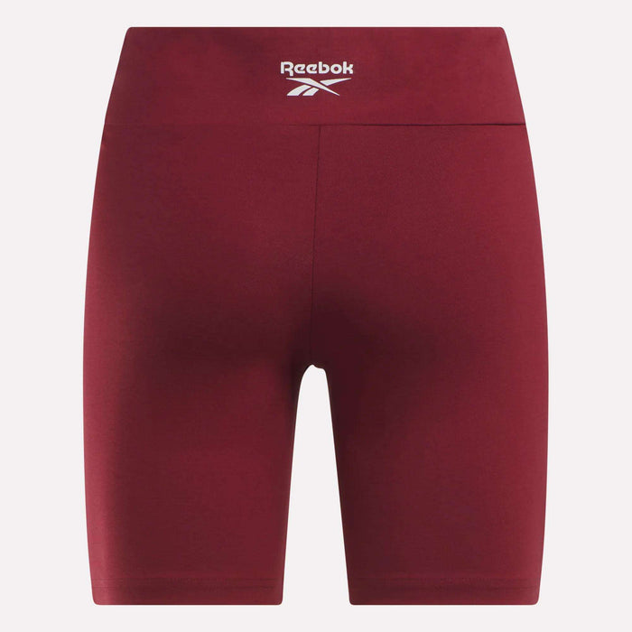 Back view of Reebok Women's Small Logo Cycle Shorts in maroon, featuring a high waist and white logo on the waistband, shown on a plain white background. Ideal for women seeking comfort and style while cycling.