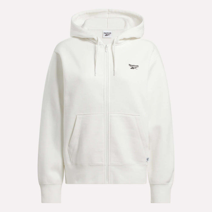 The Reebok Women's Small Vector Full Zip Sweatshirt is a plain white hoodie with drawstrings, front pockets, and a small black Reebok logo on the left chest.