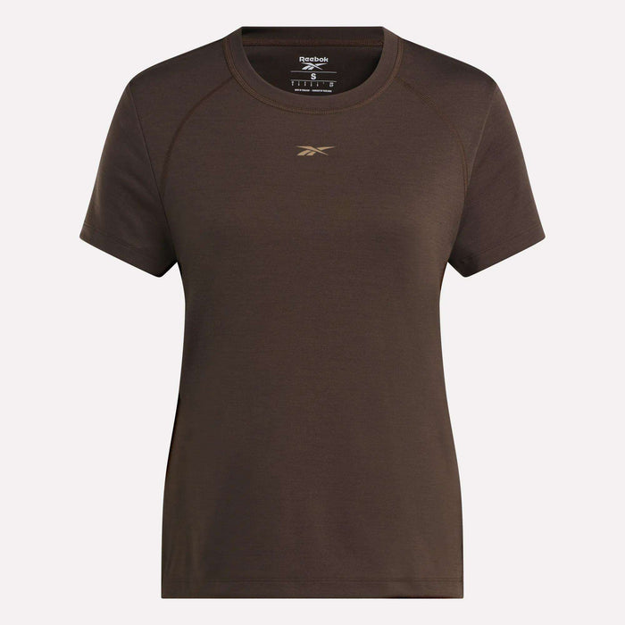 The Women's Training T-Shirt by Reebok showcases RBK-DRY technology, a small gold logo on the chest, and comes in plain brown. Displayed against a light background.