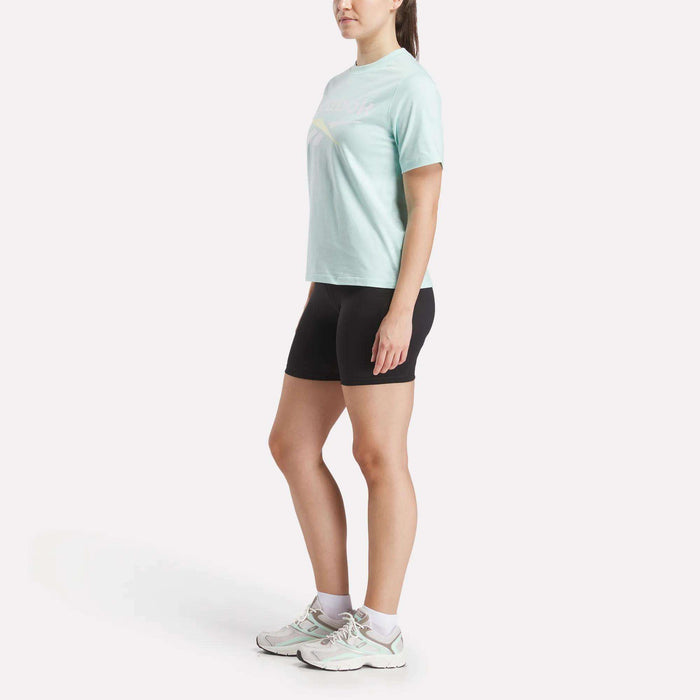 A woman in shorts and a Reebok Women's Two-Color Logo Crew Short Sleeve Tee.