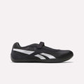 The Reebok Women's Ultra Lo Mary Jane Shoes are black low-profile runners with a single Velcro strap and white side stripes, shown in profile on a plain light background.