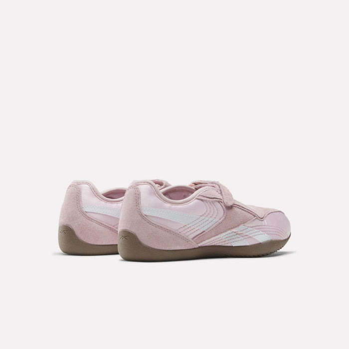 The Reebok Women's Ultra Lo Mary Jane Shoes in pink, featuring white stripes and gum soles, display a sleek low-profile design from back and side views against a plain white background.