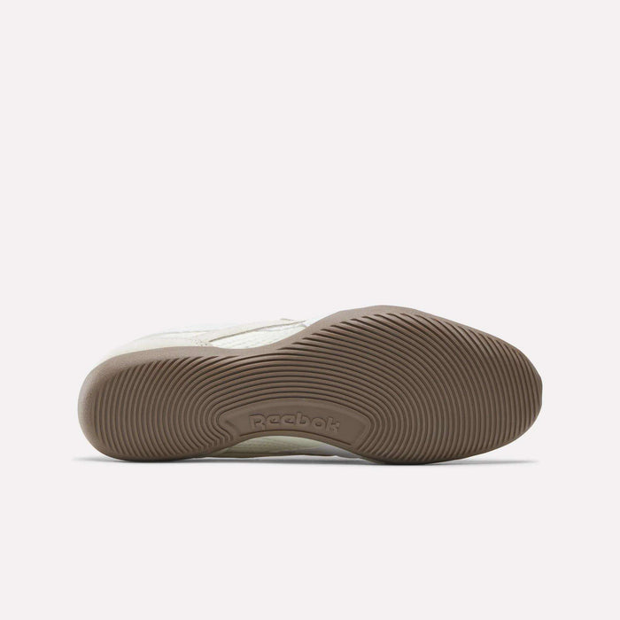 The outsole view of the Reebok Women's Ultra Lo Mary Jane Shoes shows a light brown rubber sole with a wavy grip pattern and the Reebok logo embossed in the center, set against a plain white background.