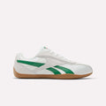 Side view of Reebok Women's Ultra Lo Shoes in Chalk/Glengreen/Gum with green accents, white laces, and a light brown sole, made from satin and suede, displayed against a plain white background.