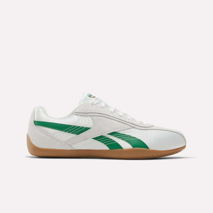 Side view of Reebok Women's Ultra Lo Shoes in Chalk/Glengreen/Gum with green accents, white laces, and a light brown sole, made from satin and suede, displayed against a plain white background.
