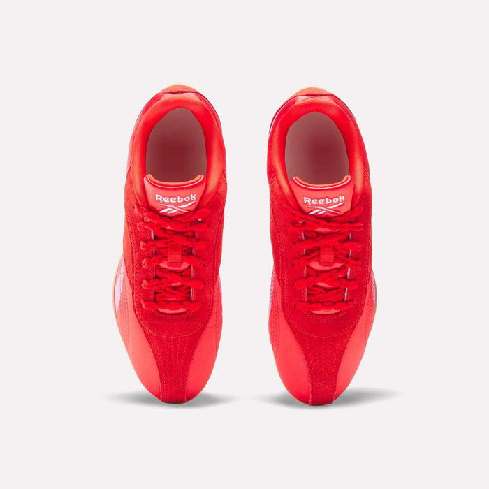 Top view of Reebok Women's Ultra Lo Shoes in bright red with white logo accents on the tongues, placed side by side on a plain white background, highlighting their sporty design.