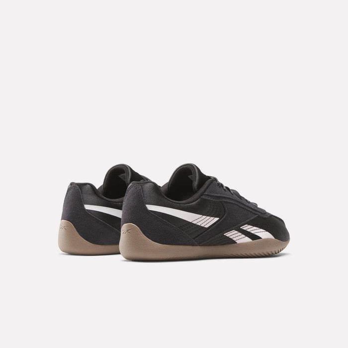 The Reebok Women's Ultra Lo Shoes are black with white stripes and beige soles, shown on a white background—one angled, one with the heel visible, highlighting their sport-inspired style.