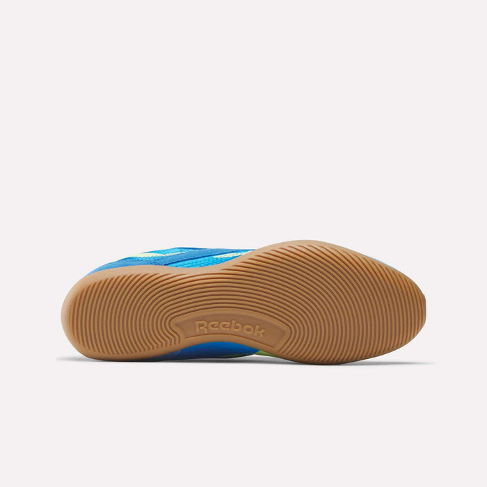 Close-up of the underside of a blue Reebok Women's Ultra Lo Shoe with a tan, textured rubber sole and central Reebok branding. The lightweight shoe is displayed horizontally on a plain white background.