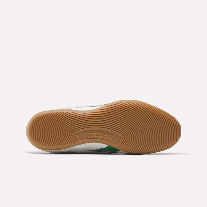 The image shows the sole of Reebok Women's Ultra Lo Shoes, featuring a light brown rubber outsole with a textured, circular grip pattern inspired by motorsport design and the Reebok logo embossed at the center.