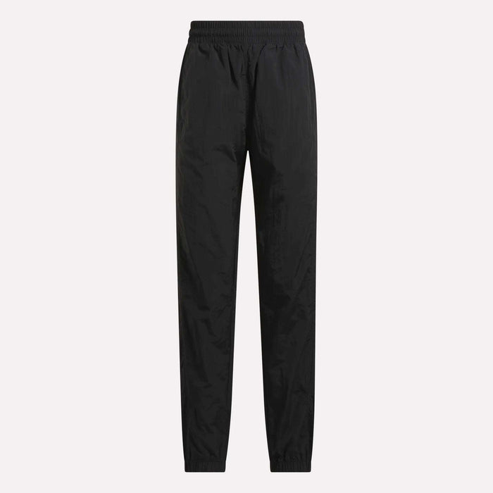 Women's Vector Track Pants by Reebok in black, featuring full length, an elastic waistband, and elastic cuffs, shown against a plain light background.