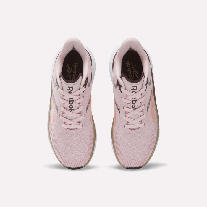 A pair of Women's Viva Speed Shoes by Reebok in light pink, shown from above, featuring white soles, pink laces, and the Reebok logo on the insoles. These breathable shoes provide both comfort and style for athletic activities.
