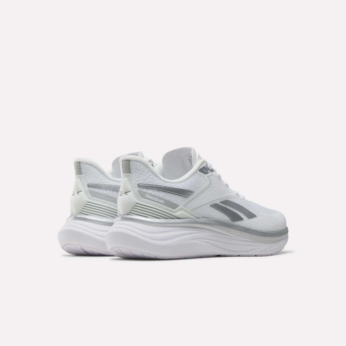 A pair of Reebok Women’s Viva Speed Shoes in white with gray accents, shown from the back-left angle on a plain light background. These breathable running shoes offer cushioned support for enhanced comfort with every stride.