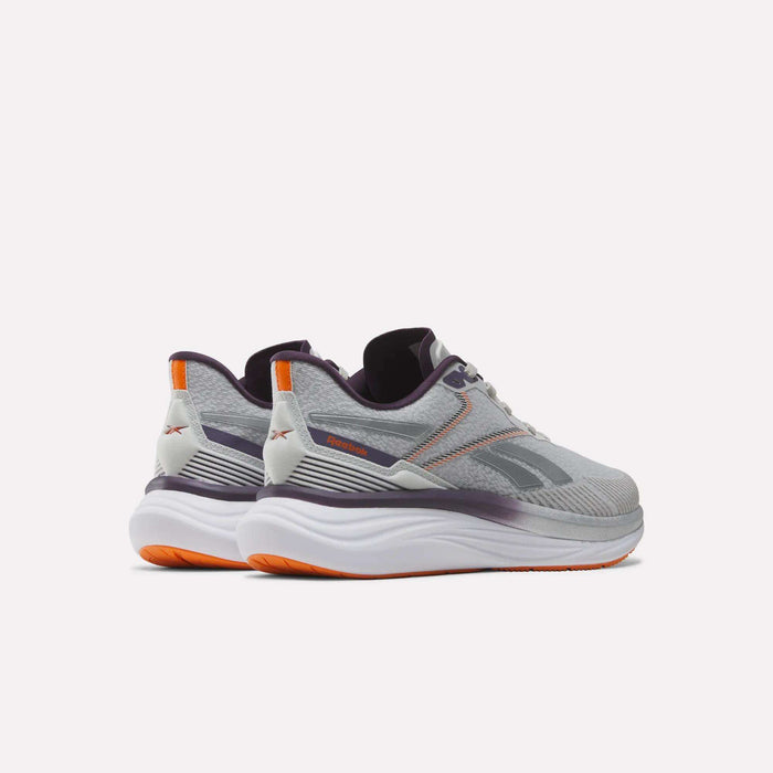 A pair of Women's Viva Speed Shoes by Reebok in gray and white, featuring purple and orange accents, designed with cushioning for enhanced comfort, shown from the back and side against a plain white background.